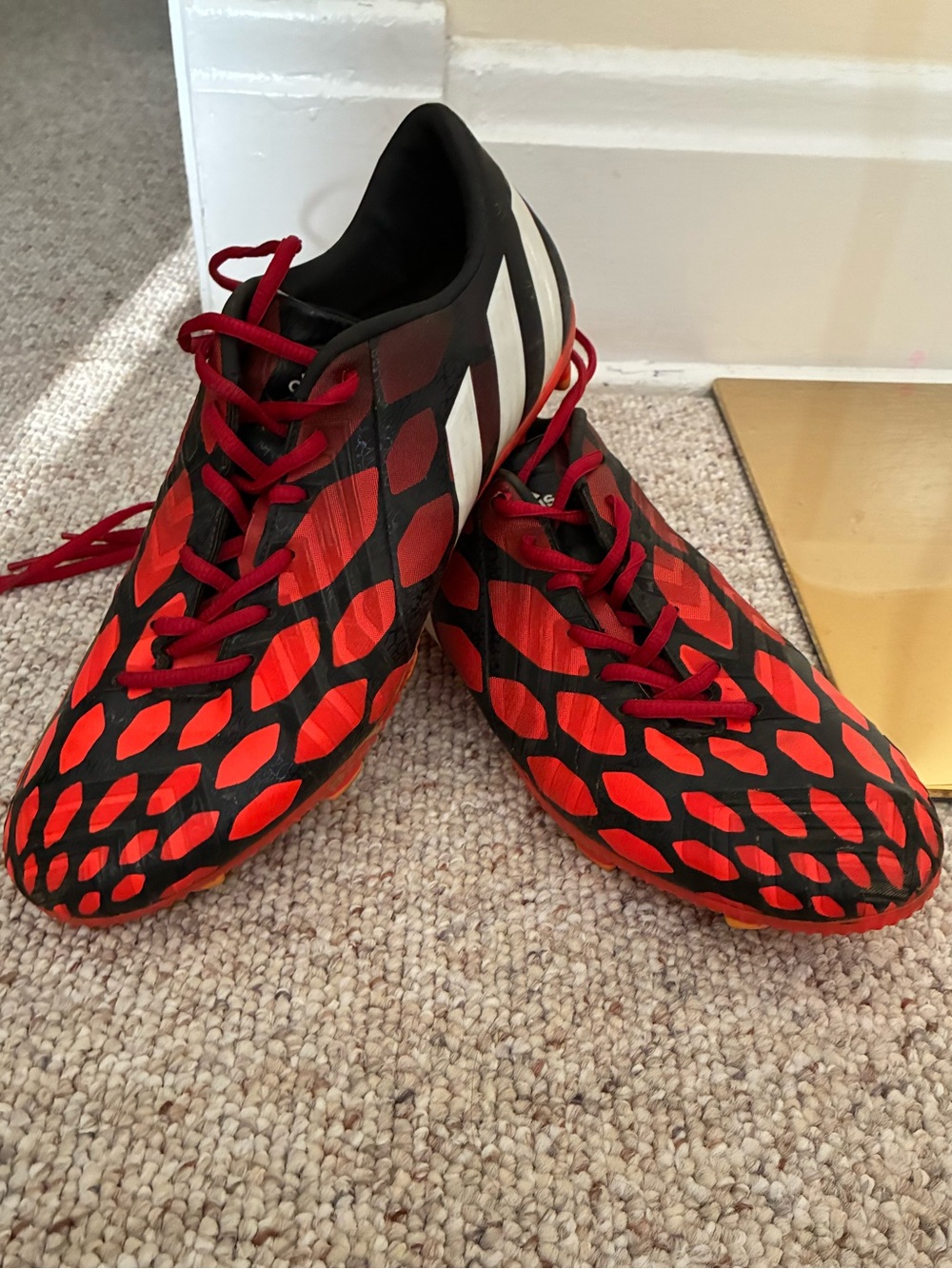 Adidas Predator soccer cleats in a red and black colorway